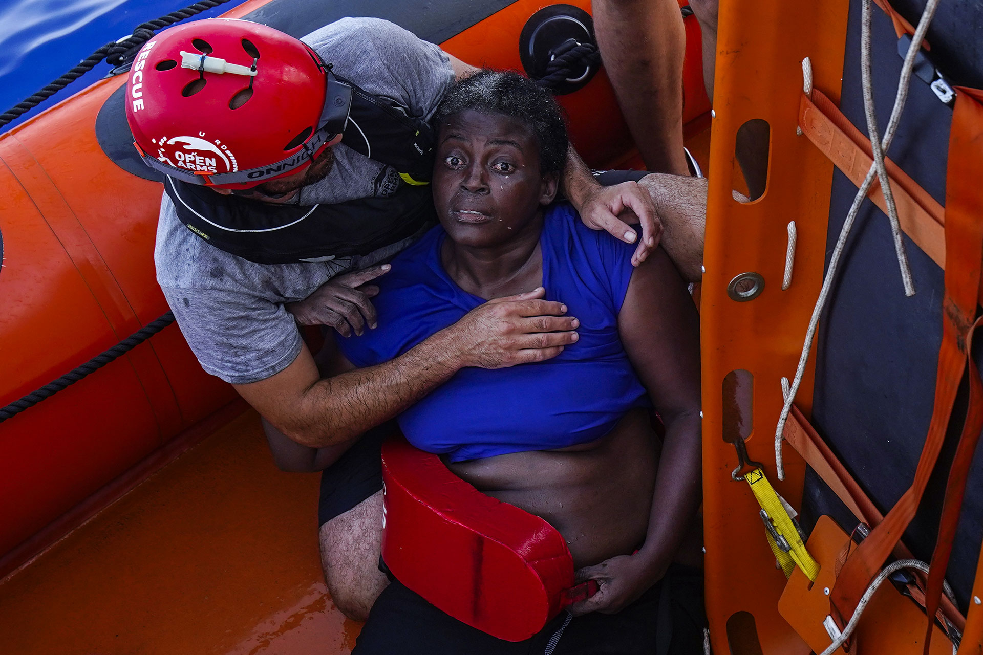 A crew member of the rescue ship from the Spanish NGO Proactiva Open Arms embraces Josepha (Cameroon) in the central Mediterranean Sea, 17 July 2018.