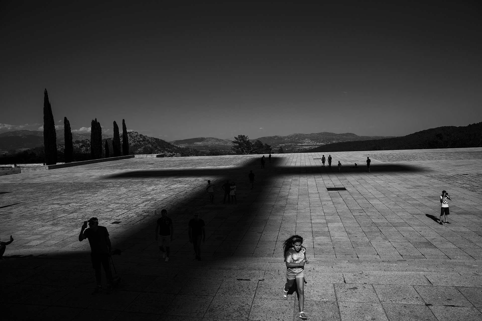 A girl runs across the esplanade of the Valle de los Caídos, a mausoleum where more than 30,000 people are still buried without the consent of their families.