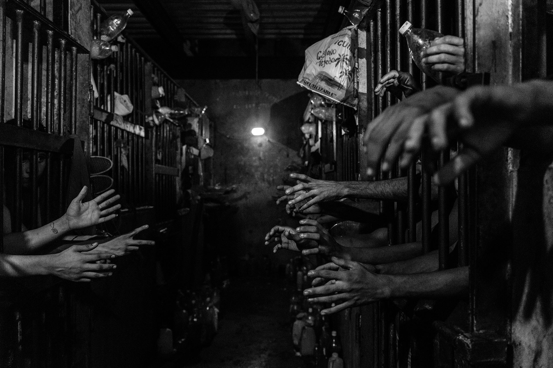 Prisoners beg for food and water in their cells in a police station in Caracas. Many of them claim to have a steady job but because of the economic crisis and the impossibility of putting food on the table, they end up taking to the streets and committing crimes.
