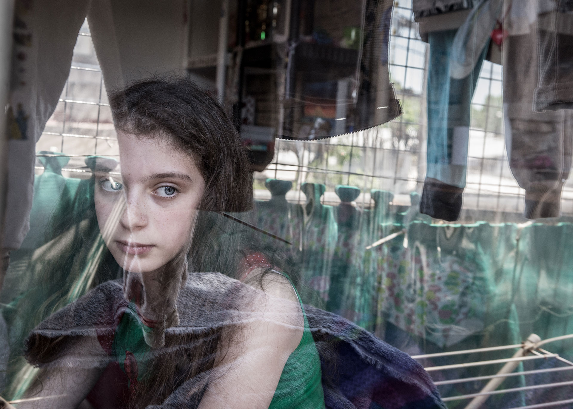 Rivka Schiller, 11 years, in her house. Her mother was victim of many death threats by her ex husband. She had filed 45 complains to the police without getting any protection from them. He also attempted to strangle her in front of her daughters. They live in a kind of prison.