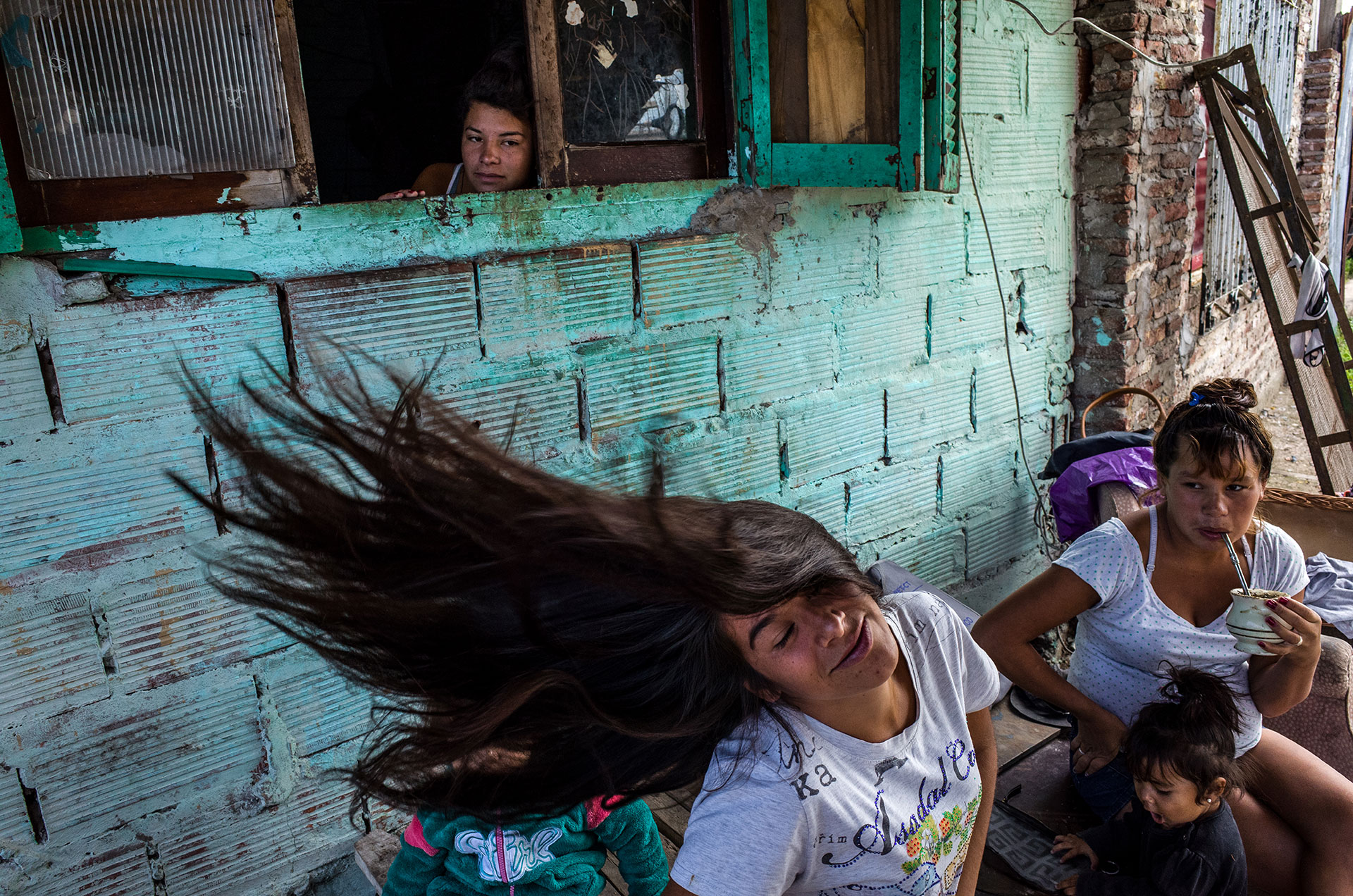 Maira Gimenez, 19 years, in front of her aunt’s house with her cousins. When she was 5, her stepfather began to abuse her and beat the brothers. After her mother’s death her brother started to consume Paco the drug. He was killed by a police officer. In 2016 Maira lost her home due to a fire.