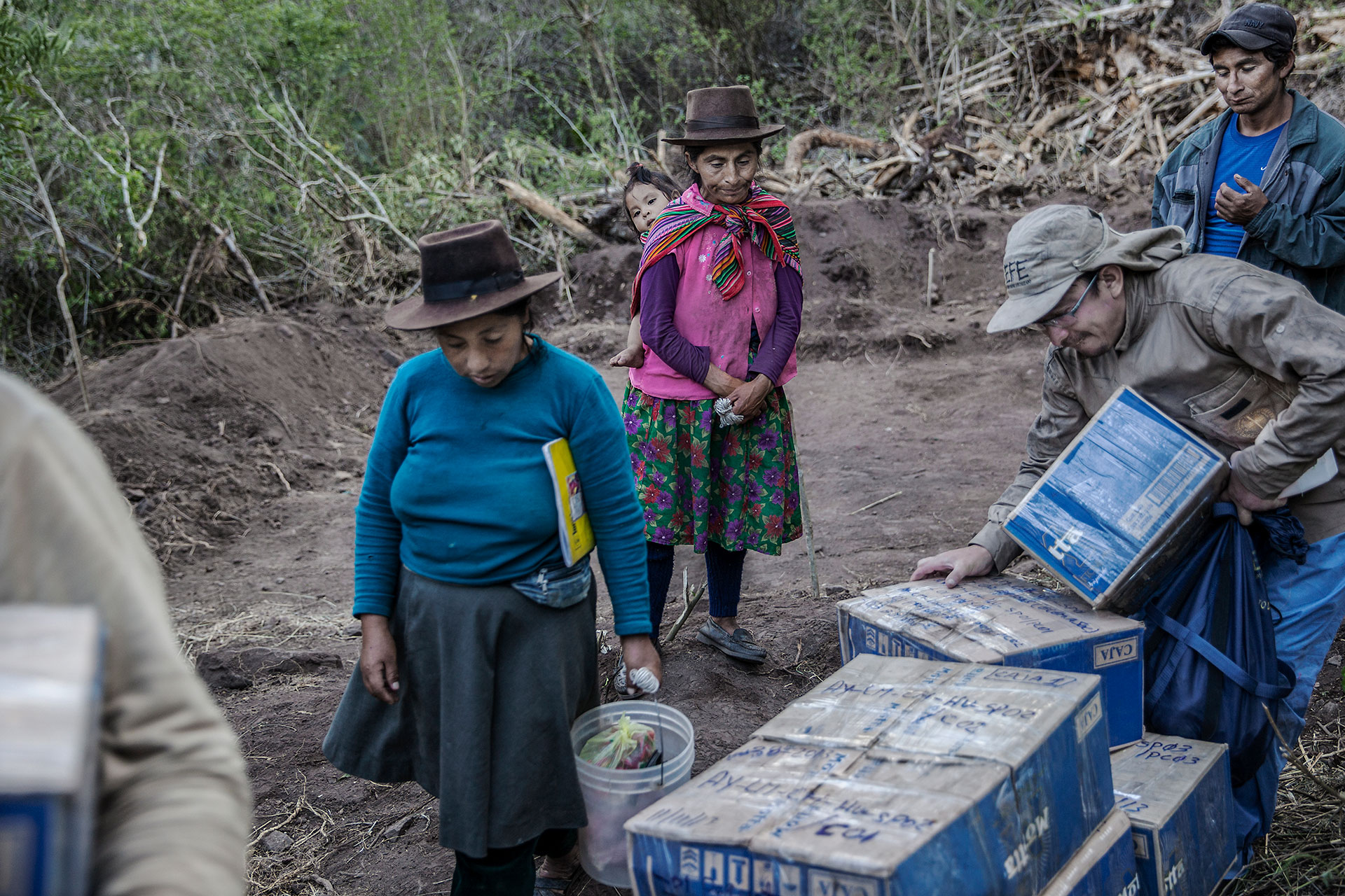 Valentín Casa (far right), his sister Teresa (center) and Valentín’s wife (left) in the place known as Suyrurupampa, where Valentín and Teresa’s mother was allegedly buried after being brutally murdered in 1986 in the east side of the Chungui district. No roads reach this point. The forensic specialists remove the bodies of 15 victims to be identified.