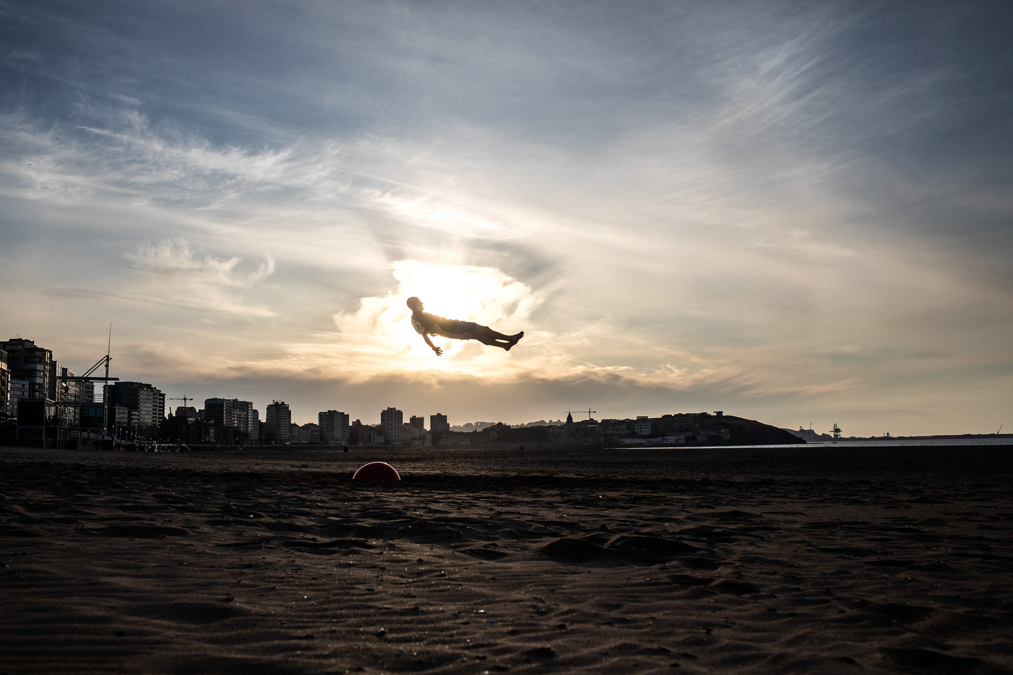 A young man is seen on the air while doing stunts on San Lorenzo beach during the period authorized by the government to play sports during phase one of de-confinement in Gijón, Asturias, Spain. May 19, 2020.