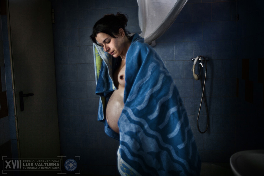 Bea, 27, after a shower. In this picture she is 7 months pregnant with her first child. Bea arrived at La Casa de la Buena Vida to recover from a heroin addiction. She comes from a broken family, was abused by her uncle and as a teenager she was caught trafficking drugs in Italy. She met and fell in love with another resident of La Casa, Rafa and plan to start a family together. Since this photo was taken, she has given birth to a healthy baby boy, also called Rafa.