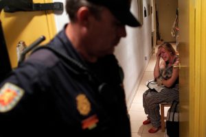 Maria Isabel Rodriguez Romero cries as police arrives to evict her and her family in Madrid, Wednesday, Sept. 25, 2013. Romero, and six family members live in an apartment of the EMVS for 24 years and they had a debt of 1,200 euros.