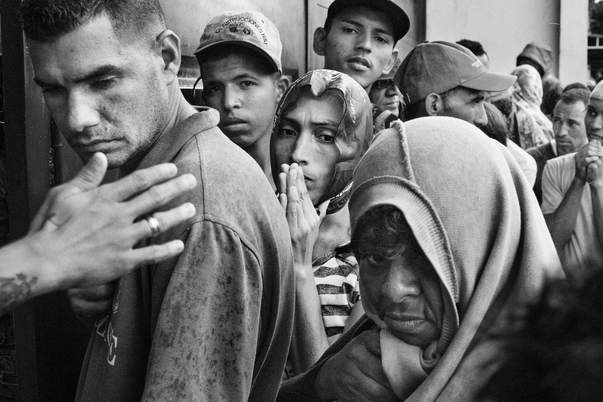 People wait in line for a free meal at a church charity organization, in Villa del Rosario, Colombia. Since March, as a lockdown to prevent contagion was imposed in Colombia, community refectories have been closed, making it more difficult for charity organizations to reach the migrants and to offer them free food.