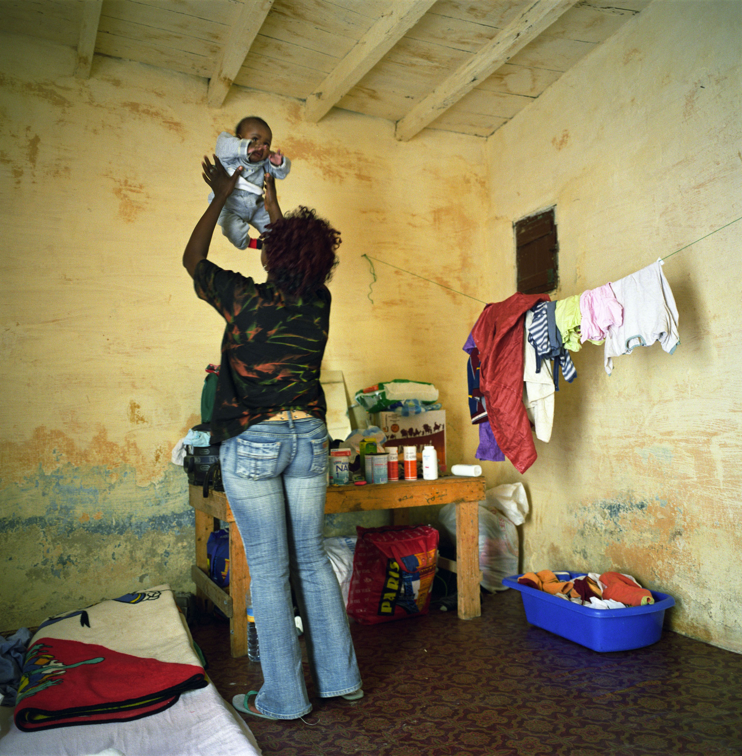 Sylla, 28, an immigrant from Kongo, has been living for one year in Mauritania with her 3-month-old baby after leaving her country due to a violent situation which left her husband dead. Trying to collect the money to make the trip to Europe, she works as a laborer in houses while she is getting some help from a Nigerian priest who runs a Catholic mission. She pays €18 rent for her makeshift shelter in Nouadhibou (Mauritania).