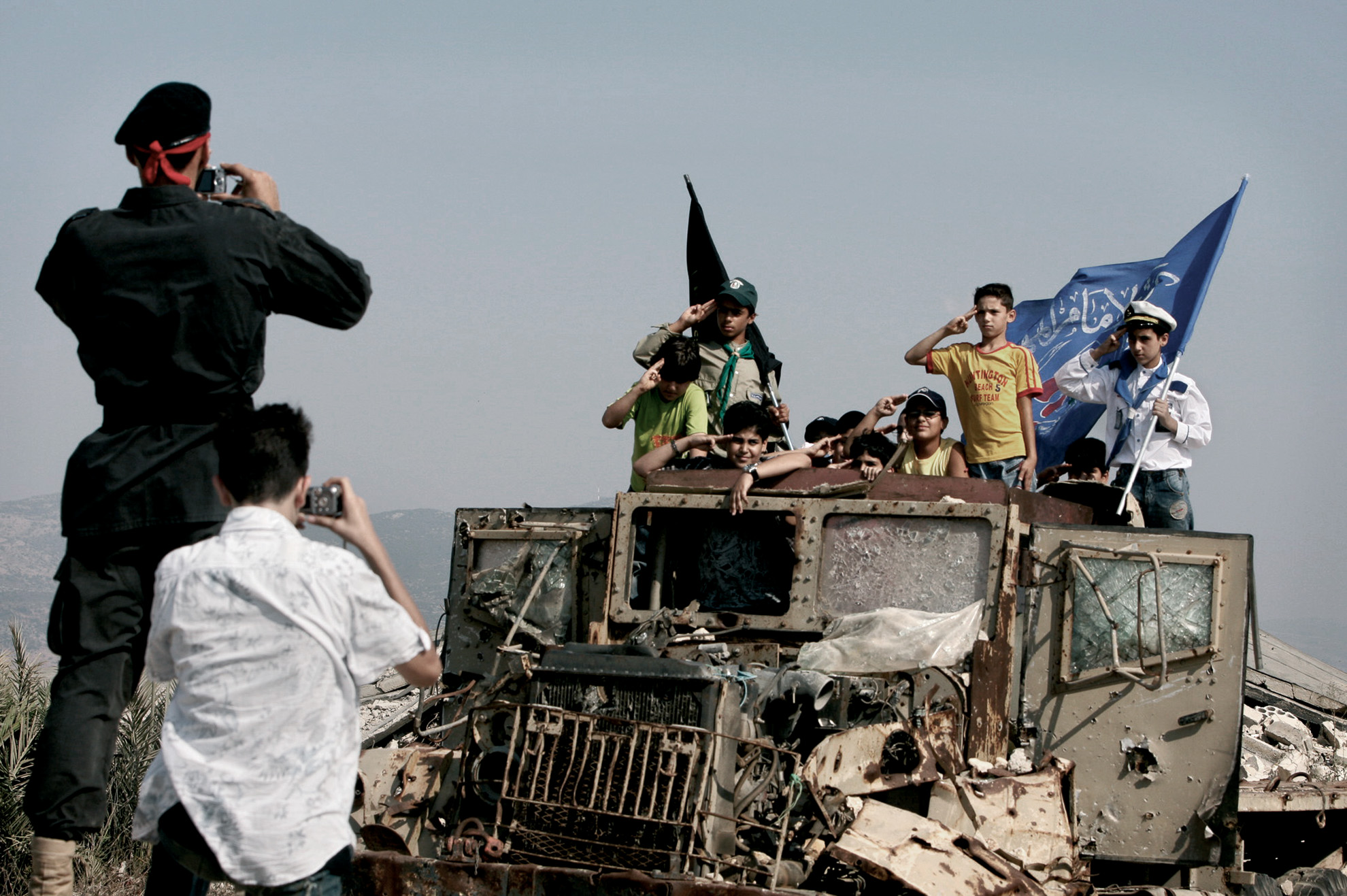 The photo shows a group of children posing on a truck destroyed in a bombing attack by the Israeli Defence Force inside the Kiham prison, south Lebanon. A Hezbollah militiaman took their photo after showing them the totally destroyed facility and telling them how Israeli soldiers used to torture Islamic prisoners there.