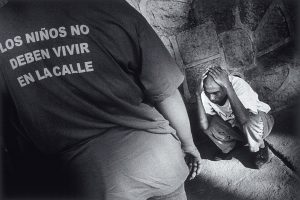 The photograph illustrates one of those moments, where a social worker wearing a T-shirt with the organization's slogan, attends to a street child who was under the effects of glue. It was taken in mid-January 1999, in one of the streets of the Honduran capital. III, January 1999.