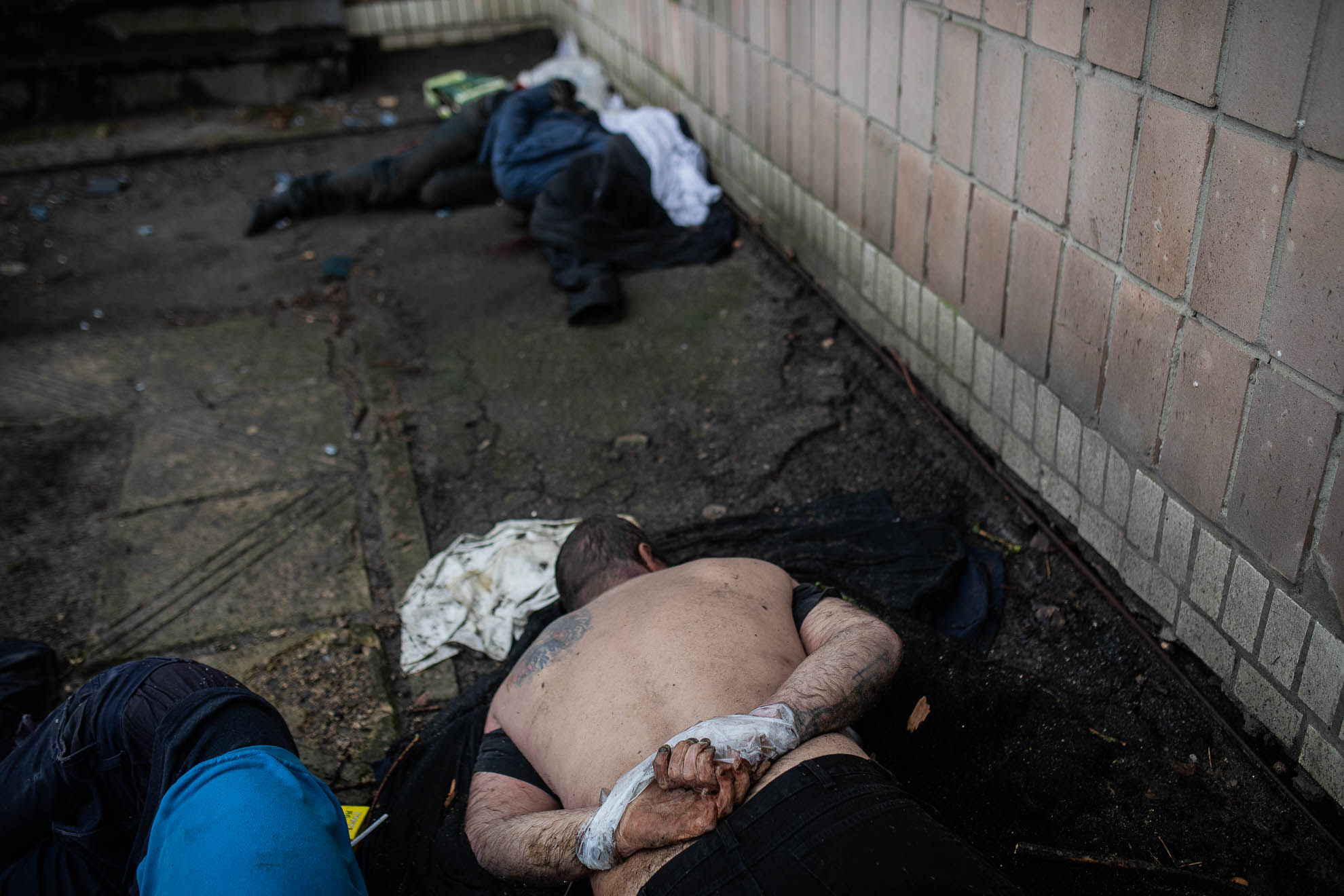 The lifeless body of Andriy, 32, lies with his hands tied behind his back, along with other corpses, in a courtyard of the building that served as headquarters for Russian troops in Bucha. His father, also named Andriy, said that his son had hidden from Russian soldiers in a cellar, but was found and executed on March 5.