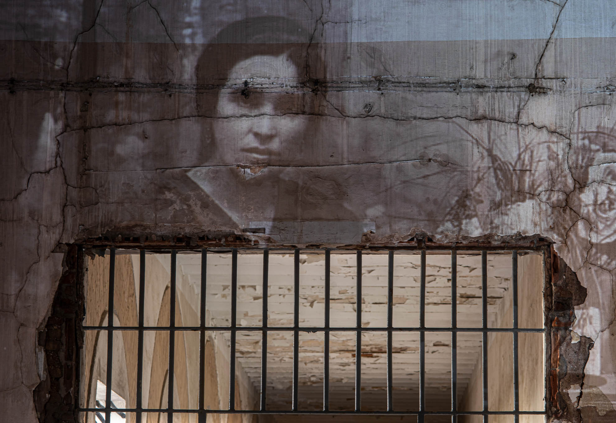 Projection of a photo of Balbina Sánchez, Huelva Provincial Prison, 2021. She was a primary school teacher in Villanueva de Los Castillejos. She was the only woman of the 21 teachers shot in the province. Catalina Gómez, one of her former students, still has photographs and letters she sent to her in prison.