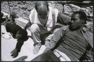 A Guardia Civil helps migrants in Tarifa, Cadiz, during the summer of 2003. An estimated 15,000 people lost their lives in the Strait of Gibraltar between 1993 and 2003. Although many people manage to reach the Strait of Gibraltar, the number of people who die at sea is also enormous. Some of the bodies found on the beaches were buried in local cemeteries under the legend "anonymous migrant".